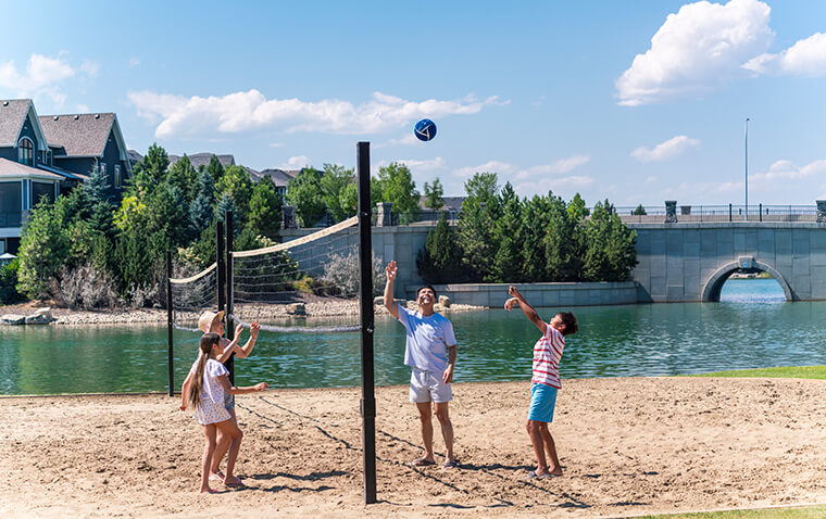 Family playing beach volleyball