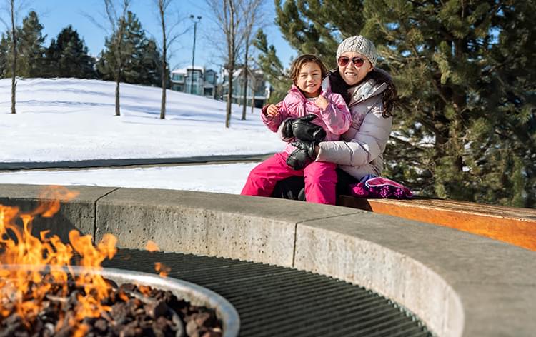 Mother and daughter by fire pit
