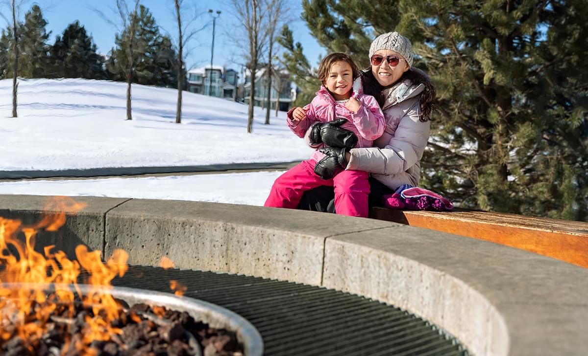 Mother and daughter by fire pit