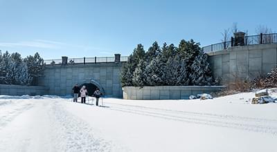 Family skis under bridge